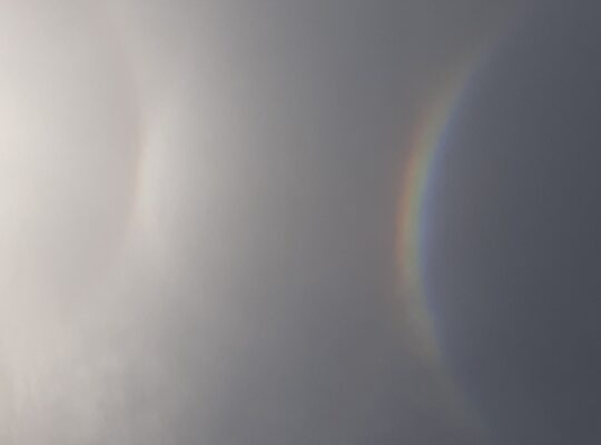Sun dog in winter sky reflecting light and symbolizing transition
